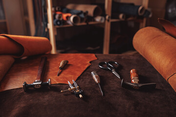 Natural leather brown color with tools, top view. Concept banner background tailor shoes maker