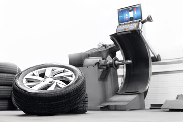 Car wheel balancing in tire service station on machine