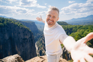 Happy man tourist make selfie photo background of sunset in mountain Tazi canyon in Manavgat Antalya Turkey