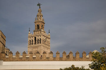 Fototapeta na wymiar Top of the giralda of Seville seen from inside the orange tree courtyard. Concept monuments, travel, culture, cathedral, Spain.