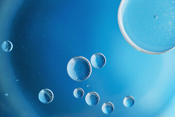 abstract light blue background with oil circles . bubbles of water close up .