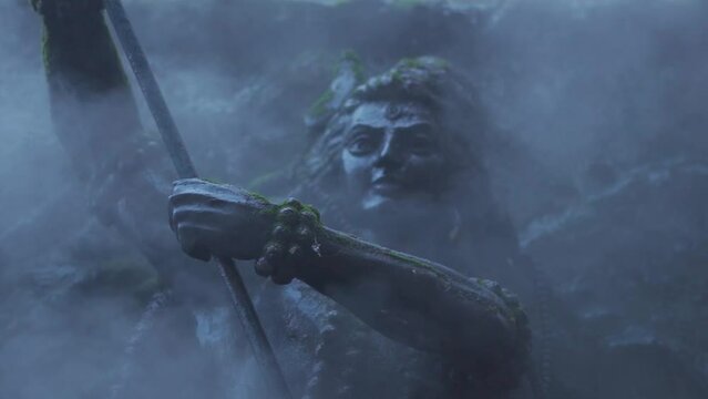 Closeup slow motion shot of fog around the statue of Lord Shiva at Manikaran Shiva Temple at Manikaran near Kasol in Himachal Pradesh, India. Fog due to water vapour of the hot water springs near it. 