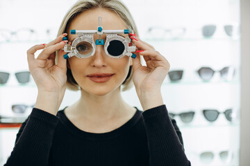 Woman making a sight diagnostics at optics store