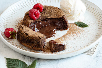 Chocolate fondant with ice cream in a plate, on a light background