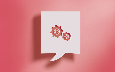 Gears Settings Control Symbol in Square Speech Bubble on Living Coral Background