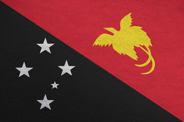 Modern shine leather background in colors of national flag. Papua New Guinea