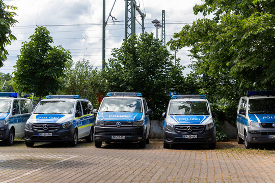 Magdeburg, Germany - June 6th, Row of many german police Mercedes and VW van cars parked at police station parking on sunny day. Civil emergency law security and traffic service vehicle in Europe