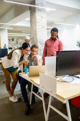 Fototapeta premium Group of happy multiethnic business people having fun and chatting at workplace office