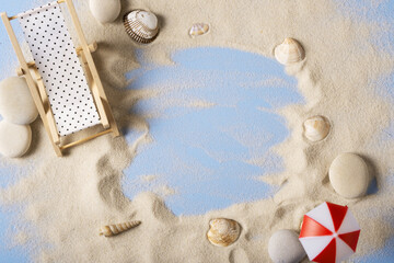 Sea sand on the beach with a chaise longue, a beach umbrella. flat lay with space for text.