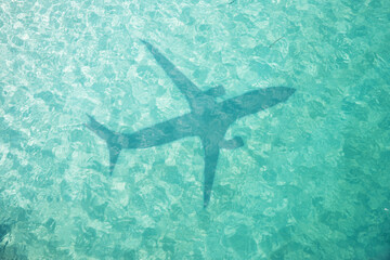 Fototapeta na wymiar Beautiful tropical beach with airplane shadow