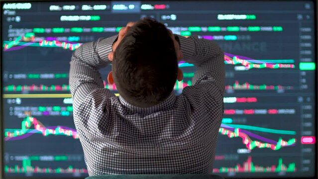 Devastated market or stock trader holding head with hands while stock market value decrease