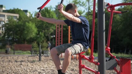 a teenage boy trains on a sports ground outdoors, he does physical exercises, a healthy lifestyle, a bright sunny day in summer

 - Powered by Adobe
