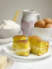 Martabak Keju, Indonesian Traditional Street Food Named Martabak Manis (Sweet Martabak) with Grated Cheese on WhiteTable. Selective focus