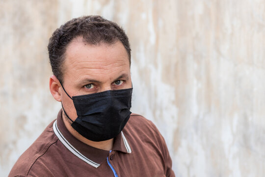A Picture Of A Young Man Wearing A Black Mask To Protect Against The Corona Virus 19