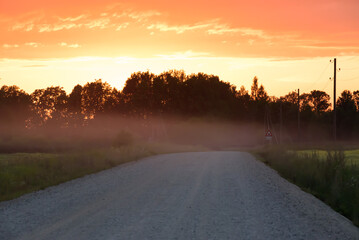 .beautiful sunset on a dirt road on a summer evening