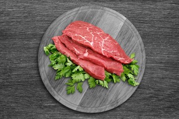 Seasoned raw beef meat steak on plate.