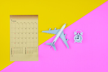 Flight itinerary / travel plan schedule, tourism concept : Paper calendar, airplane, white clock on...