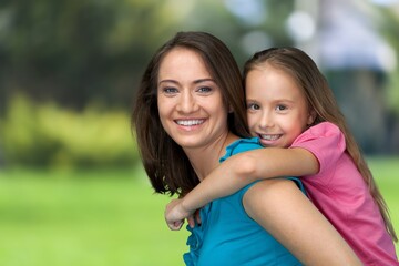 Obraz premium Happy mother having fun with her daughter outdoor