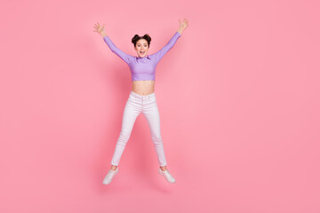 Full size photo of cheerful satisfied person jumping raise hands isolated on pink color background