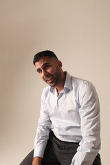Portrait of bearded brutal young man on white background. Vertical mock-up.