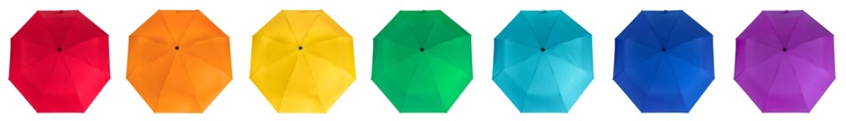 Set of rainbow colors umbrellas isolated on white background. Top view. © MadGladNat