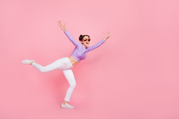 Fototapeta na wymiar Full length body size view of attractive cheerful slender girl having fun flying isolated over pink pastel color background