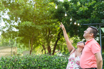 Latin couple standing looking at trees