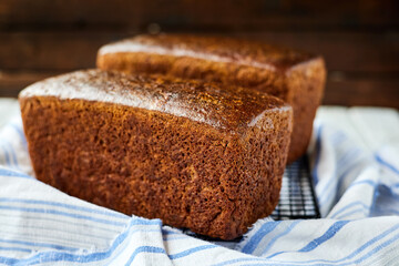 Freshly baked homemade rye bread on a textile background. Close-up, selective focus