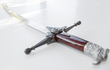 Obraz premium Cossack saber on white table, selective focus