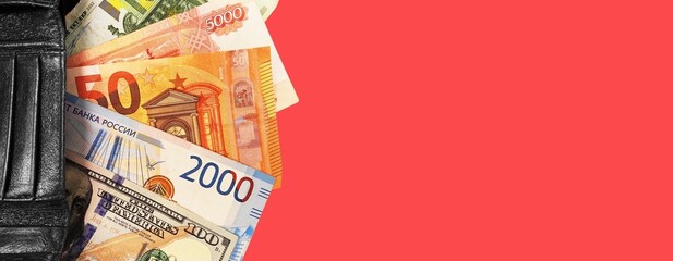 Top view of an open wallet with money. Close-up of a multi-currency wallet. Euro, dollar, ruble banknotes isolated on white background.Cash. The concept of financial literacy and savers