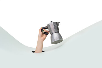 Female hand holding stovetop espresso coffee maker on clean white and green background