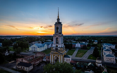 Bell tower of the orthodox church at sunrise, Russia Golden Ring town Suzdal (aerial drone photo). Suzdal, Russia