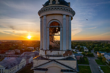 Bell tower on a christian church on a sunrise (aerial drone photo). Suzdal, Russia