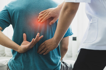 A man with back pain sees a doctor so the doctor is diagnosing men's back pain and shoulder pain.