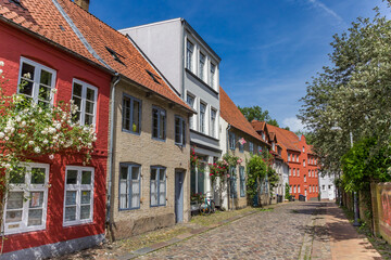 Fototapeta na wymiar Cobblestoned street in the historic center of Flensburg, Germany