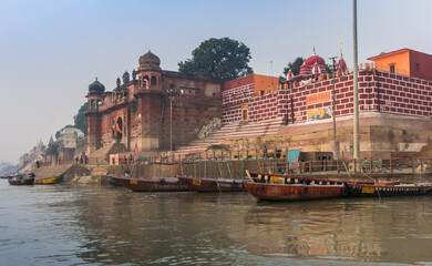 Boats and historic buildings at the Chet Singh Ghat in Varanasi, India