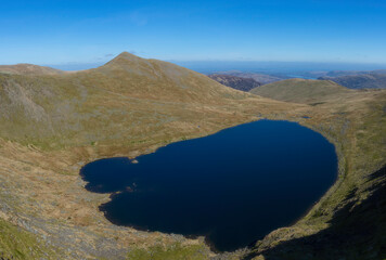 Red Tarn. View from Helvellyn in Lake District, UK, on a beautiful day with a clear blue sky and fantastic weather.
Majestic mountain landscape scene.