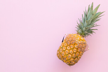 Hipster pineapple with trendy sunglasses against pink background. Minimal summer concept.