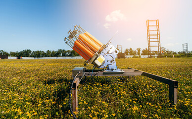 Close up plat machine with orange shooting plate for shooting-ground training on field with grass