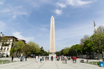 Istanbul, Turkey - April 2022: Tourists around Ancient Egyptian Obelisk of Theodosius in Istanbul
