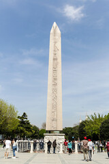 Istanbul, Turkey - April 2022: Tourists around Ancient Egyptian Obelisk of Theodosius in Istanbul