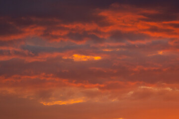 Colorful clouds of various shades on sunrise sky. Abstract and dramatic clouds background.
