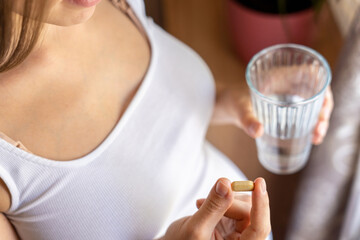 Pregnant medication vitamin pill. Happy young pregnant woman holding supplement vitamin pill. Diet...