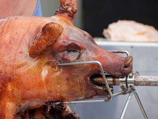 Close up of a grilled suckling pig on a spit