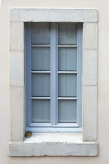 Fototapeta na wymiar French blue window with an ashtray full of stubs in a stone wall