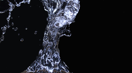 Isolated splashes of water on a black background. Abstract background. Ecological concept.