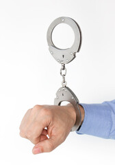 hand buckled in handcuffs, on an isolated white background