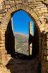 beautiful stone arch in the ruins of the abandoned ancient village of Gamsutl, Dagestan