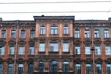 Fototapeta premium Minimalist architecture building facade of old historic house exterior. Decorative ornamental design elements of classic European style apartment building front view in Saint Petersburg, Russia