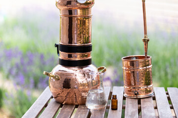 Distillation of lavender essential oil and hydrolate. Copper alambic for the flowering field.